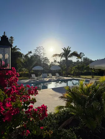 a spacious bathroom with a double vanity sink a large mirror and a bathtub