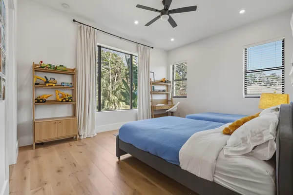 a bedroom with two beds and painting on the wall