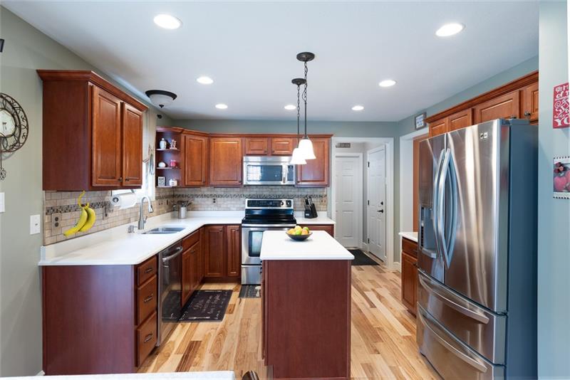 2317 Mcdevitt Road Sewickley, PA 15143 - Photo 3 of 25 Kitchen with pendant lighting over island, upscale appliances, quartz countertops