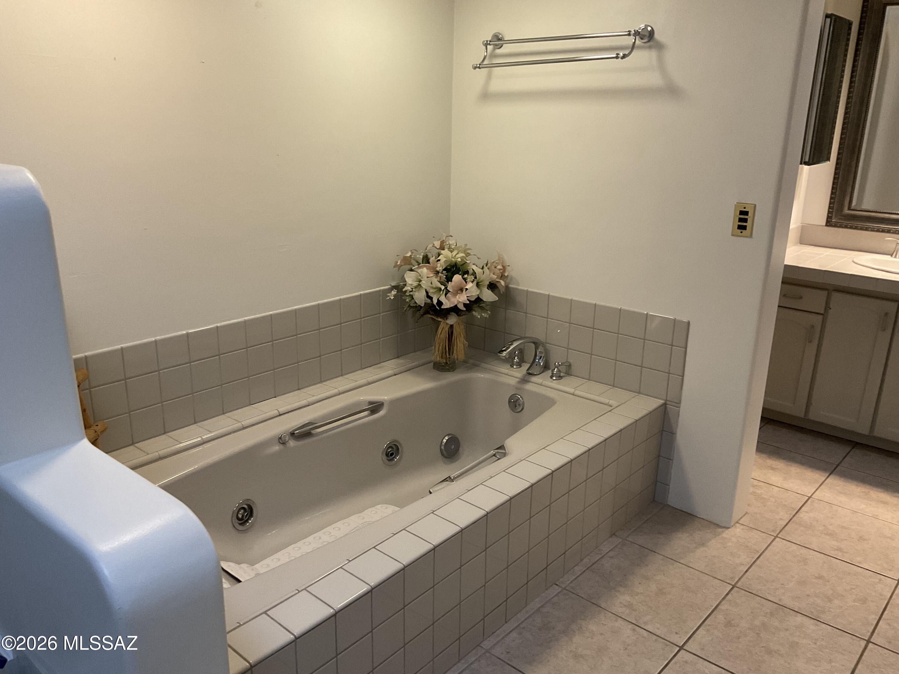 4060 North Swan Road Tucson, AZ 85718 - Photo 15 of 47 a bathroom with a tub sink and vanity
