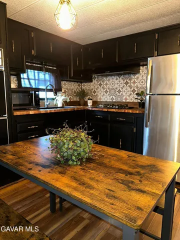 a kitchen with stainless steel appliances wooden cabinets and stove