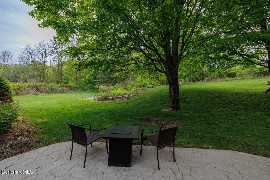 45 State Line Road West Stockbridge, MA 01266 - Photo 27 of 34 a view of a backyard with table and chairs potted plants and large tree