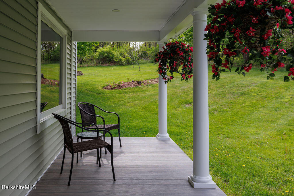 45 State Line Road West Stockbridge, MA 01266 - Photo 4 of 34 a view of a porch with a table chairs and a yard