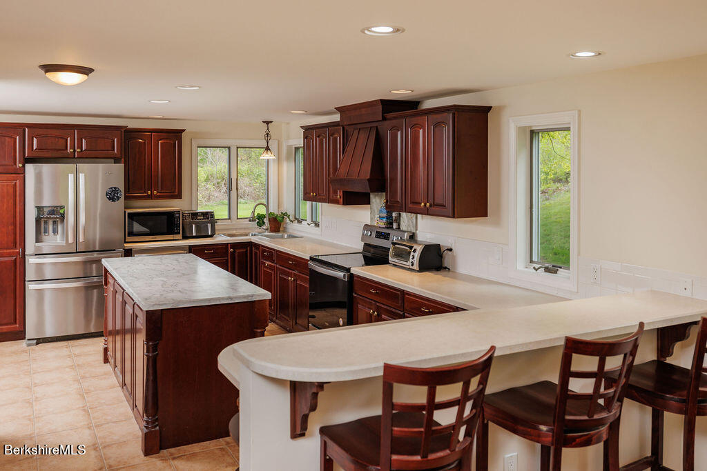 45 State Line Road West Stockbridge, MA 01266 - Photo 9 of 34 a kitchen with a table chairs sink and refrigerator