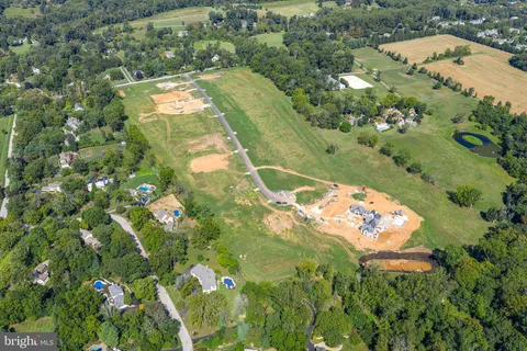 an aerial view of a house a yard and mountain