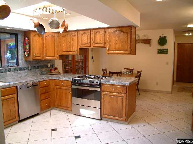 1635 Heitman Court Reno, NV 89509 - Photo 5 of 9 a kitchen with stainless steel appliances granite countertop a stove a sink and a microwave