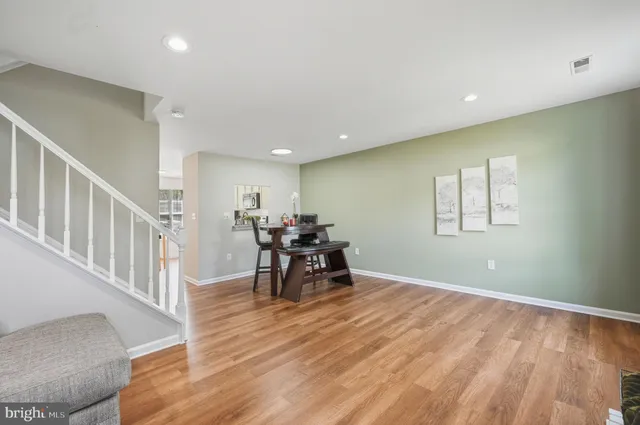 a view of a room with furniture and wooden floor