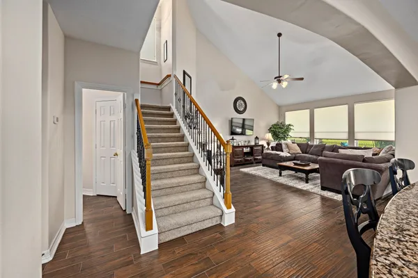 a living room with furniture a fireplace and a large window