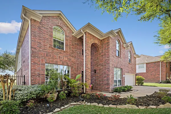 a front view of a house with yard and green space