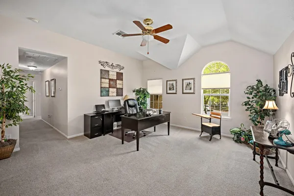a living room with furniture a chandelier and a window