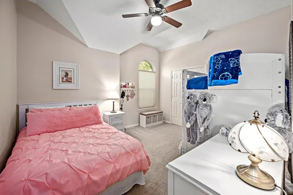 a bedroom with a bed and window