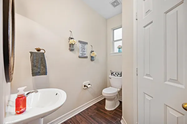 a kitchen with a table chairs refrigerator and cabinets
