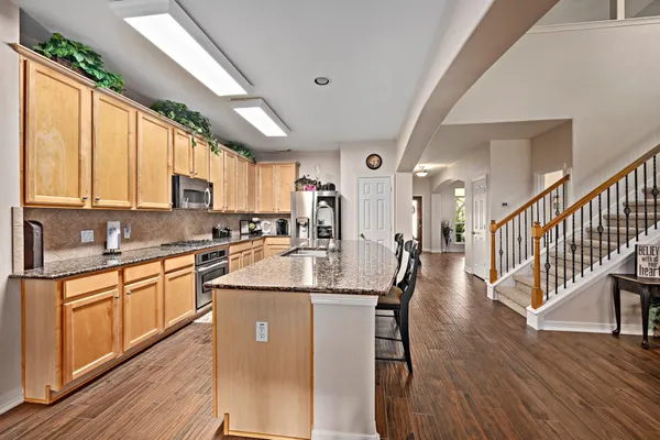 a kitchen with stainless steel appliances granite countertop a stove oven and a refrigerator