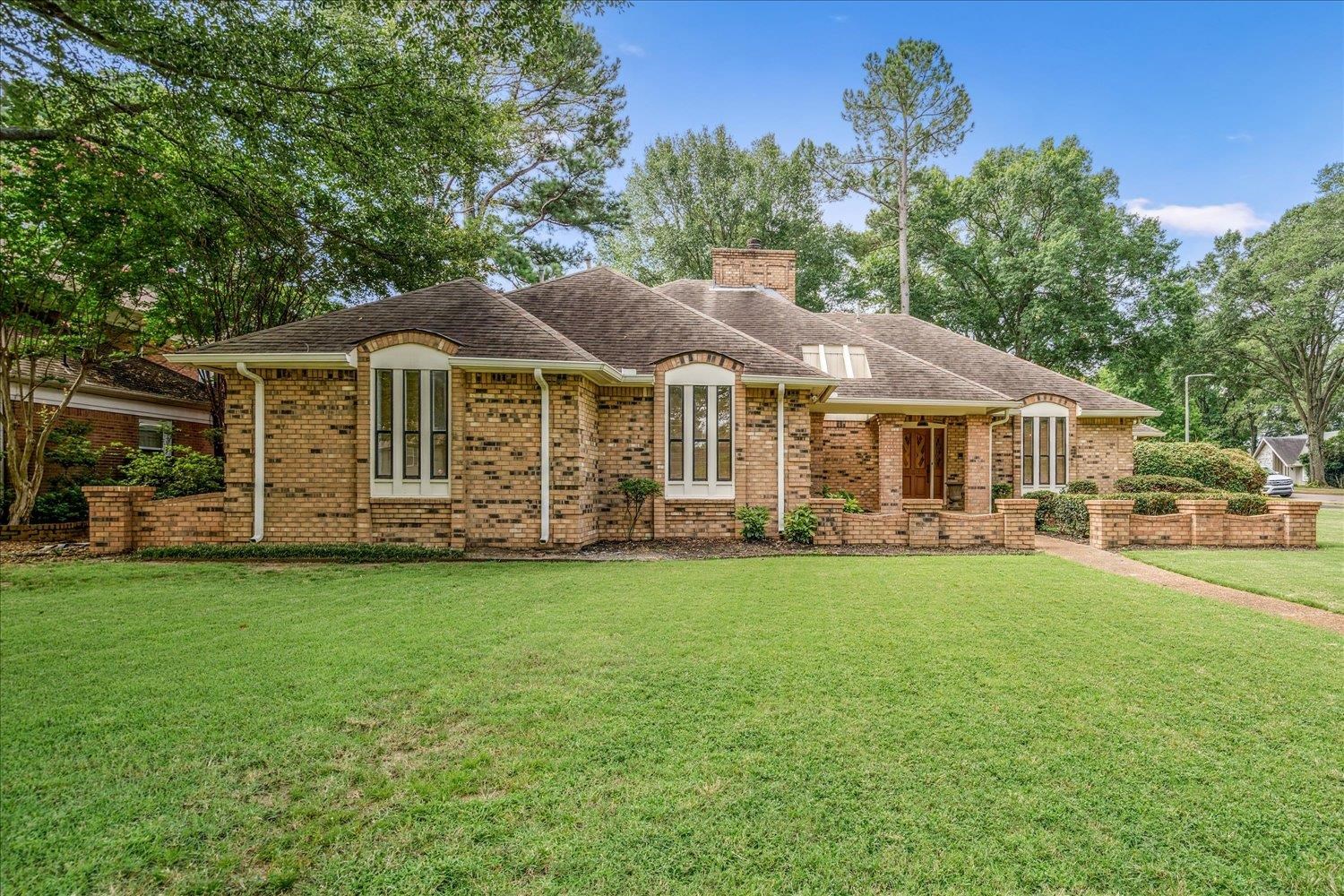 6677 Neshoba Road Memphis, TN 38120 - Photo 2 of 40 a front view of a house with a garden
