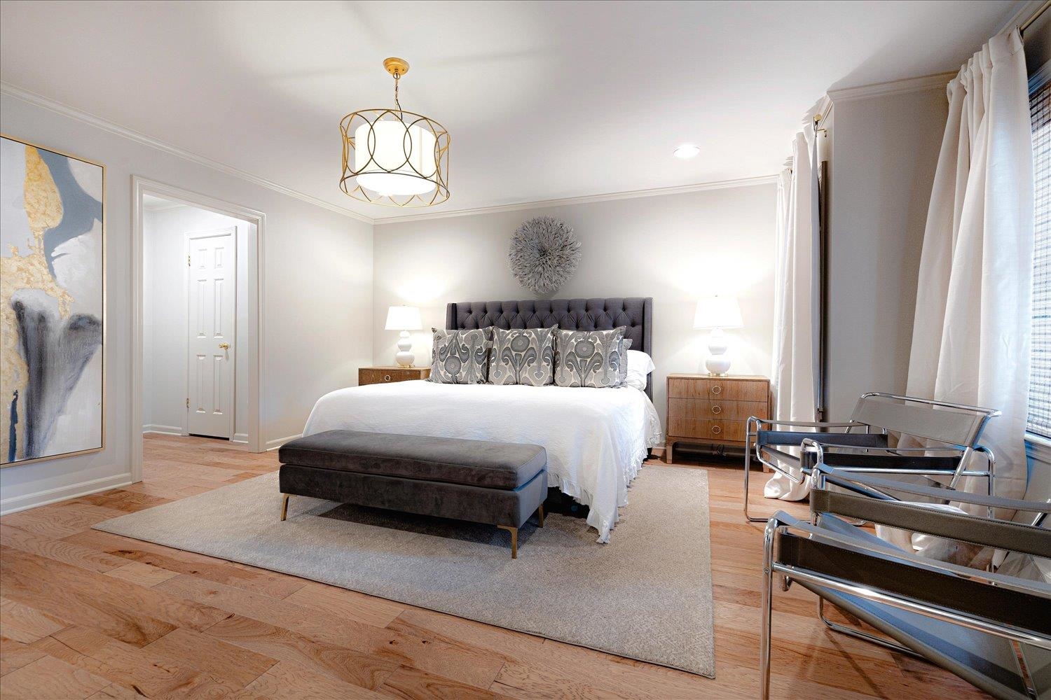 6677 Neshoba Road Memphis, TN 38120 - Photo 26 of 40 a spacious bedroom with a bed and a chandelier