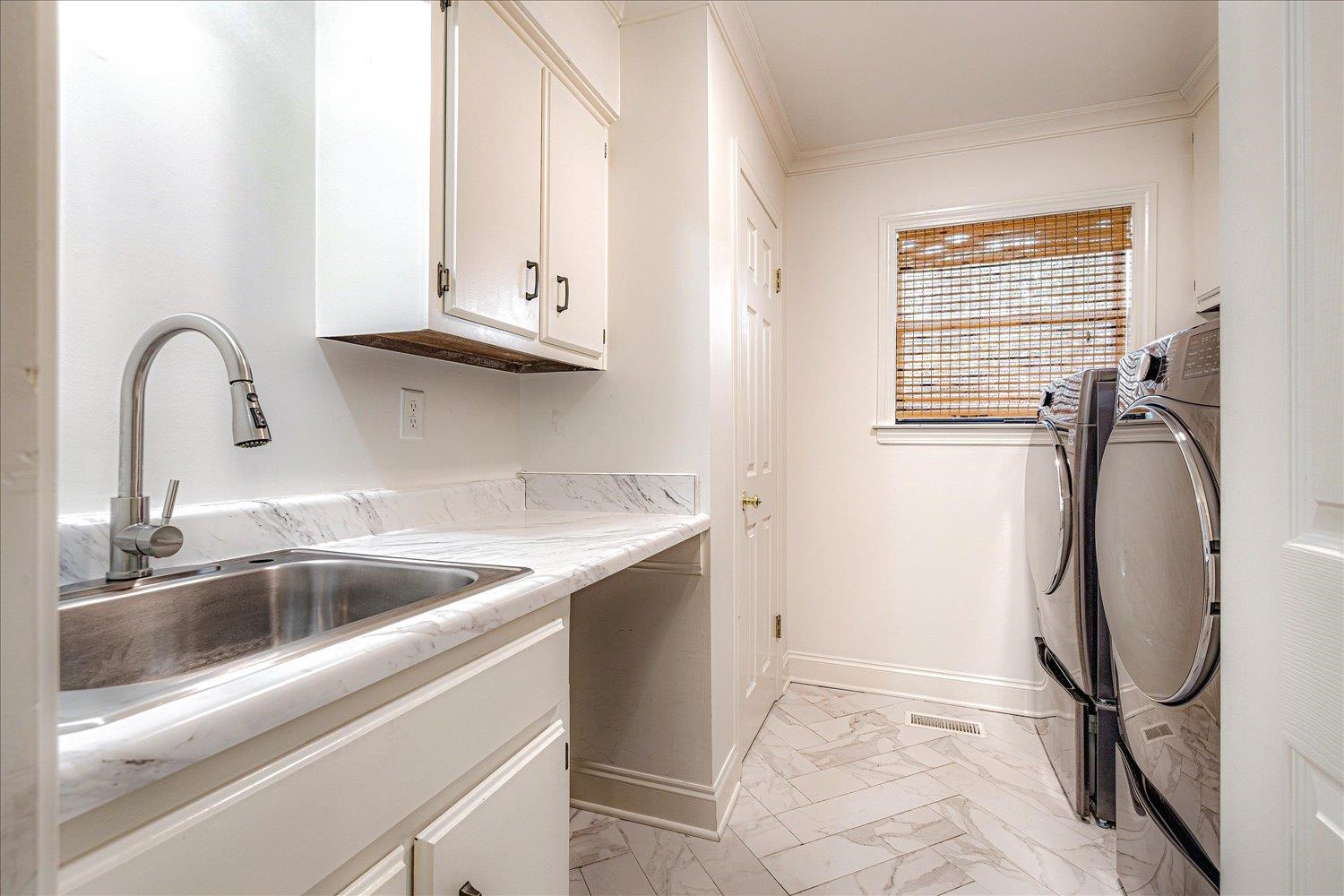 6677 Neshoba Road Memphis, TN 38120 - Photo 32 of 40 a close view of a sink and dishwasher in a bathroom