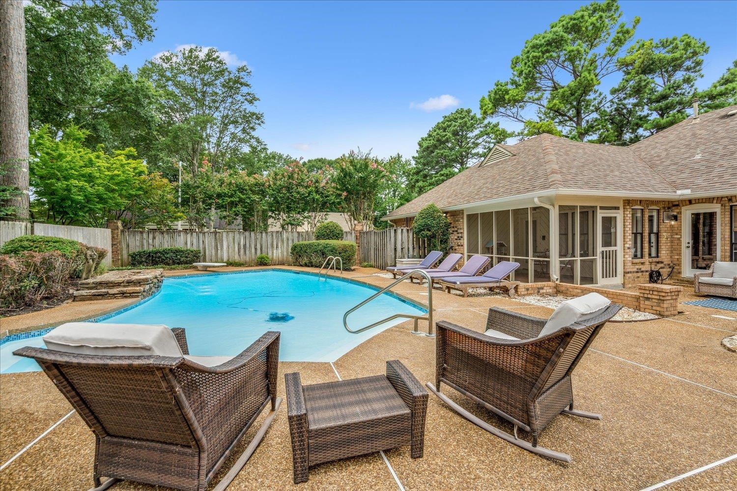 6677 Neshoba Road Memphis, TN 38120 - Photo 37 of 40 a view of a house with a swimming pool and sitting area