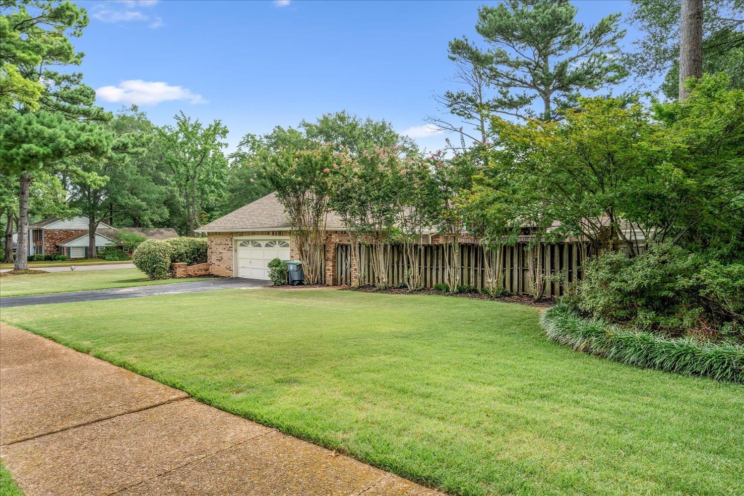6677 Neshoba Road Memphis, TN 38120 - Photo 6 of 40 a house with green field in front of it