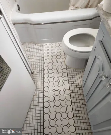 a bathroom with a toilet and a sink