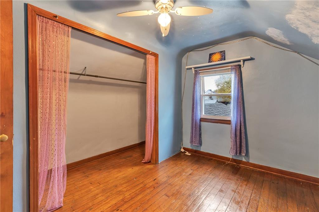 290 Jackson Street Rochester, PA 15074 - Photo 12 of 16 an empty room with wooden floor cabinet and windows