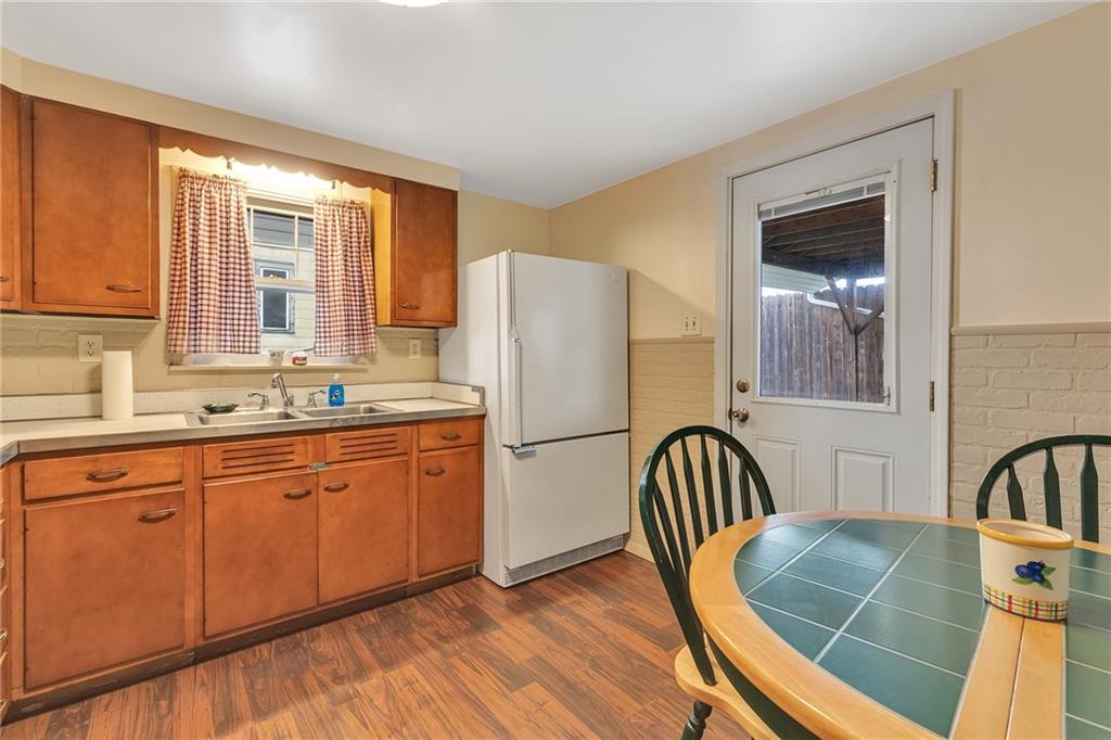 290 Jackson Street Rochester, PA 15074 - Photo 7 of 16 a kitchen with stainless steel appliances granite countertop a refrigerator a sink a stove and island with wooden floor