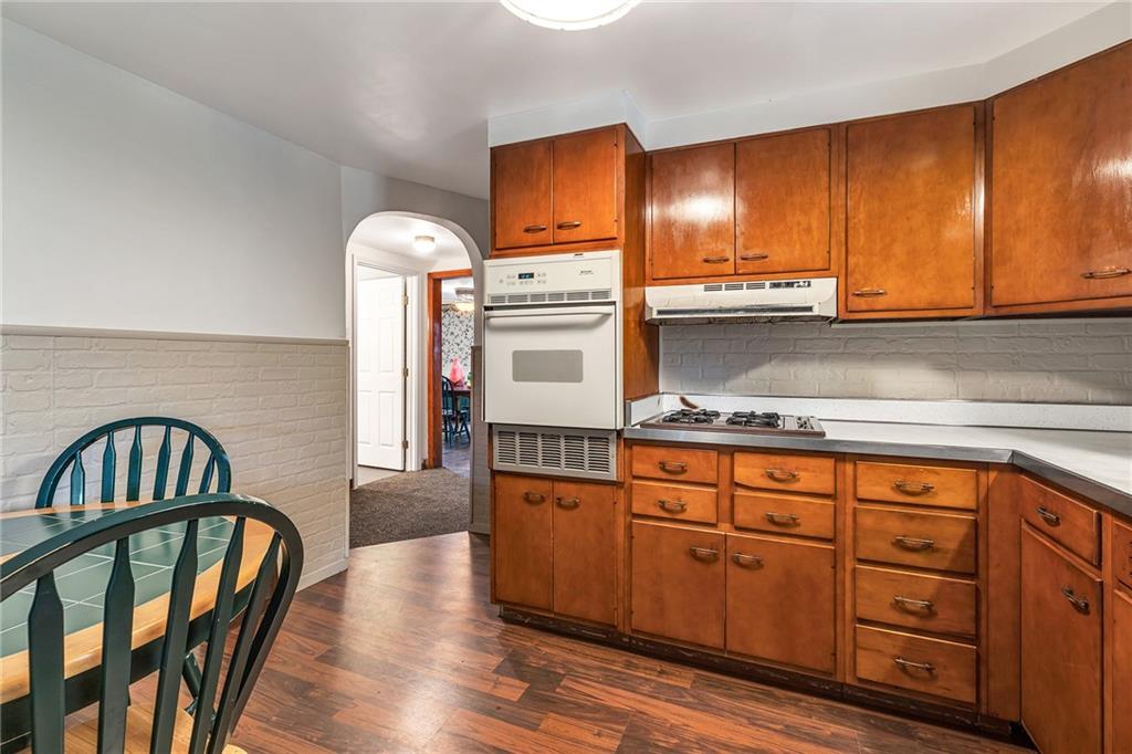 290 Jackson Street Rochester, PA 15074 - Photo 8 of 16 a kitchen with stainless steel appliances granite countertop a stove a sink dishwasher and cabinets with wooden floor