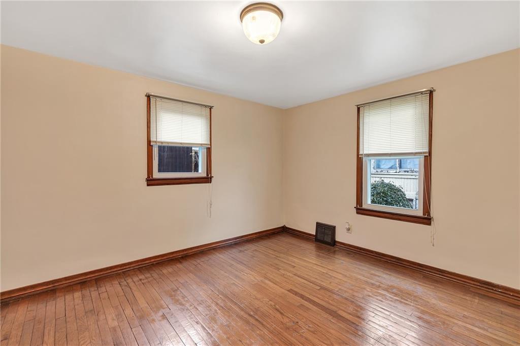 290 Jackson Street Rochester, PA 15074 - Photo 10 of 16 a view of an empty room with wooden floor and a window