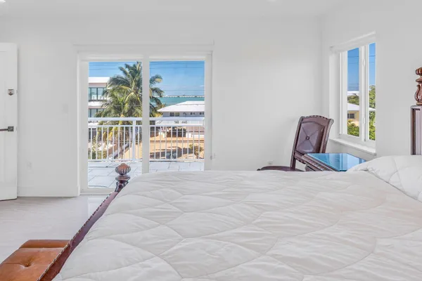 a view of a bedroom with furniture and window