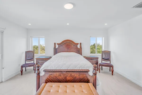 a bedroom with a bed and a chair