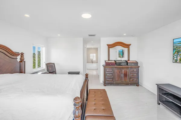 a bedroom with a bed and dresser