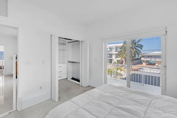 a bedroom with a bed and glass door