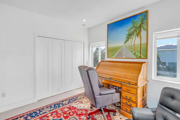 a living room with furniture a window and a flat screen tv