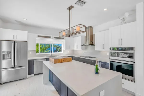 a kitchen with a sink a stove and a window