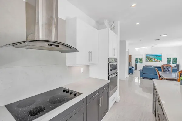 a kitchen with stainless steel appliances a sink a stove a refrigerator and cabinets