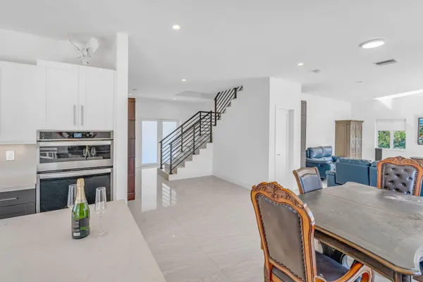 a kitchen with stainless steel appliances granite countertop a refrigerator and a sink