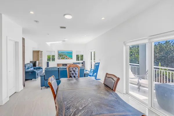 a dining room with wooden floor and furniture