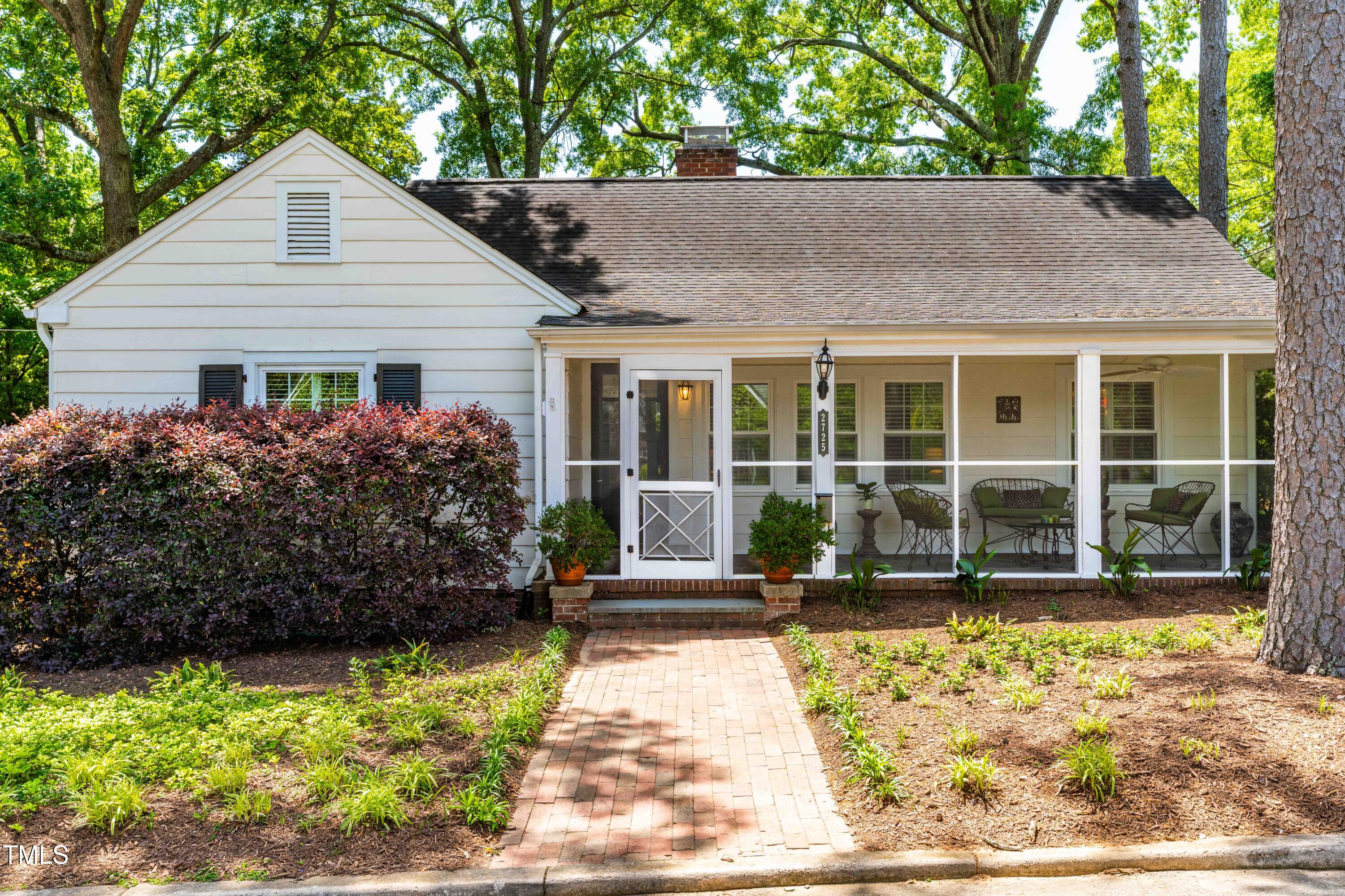 2725 Bedford Avenue Raleigh, NC 27607 - Photo 1 of 48 a front view of a house with a garden