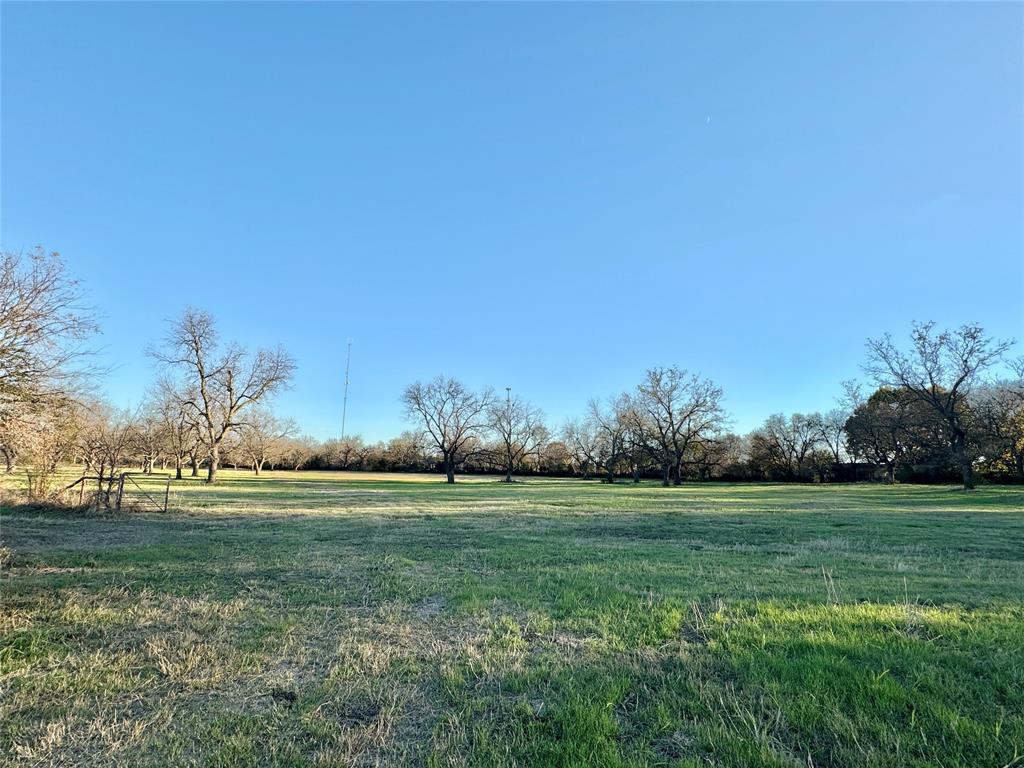 738 Cole Street Gainesville, TX 76240 - Photo 11 of 23 a grassy field with trees in the background