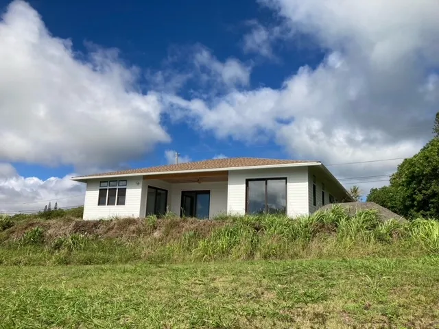 a view of house with yard and sitting space