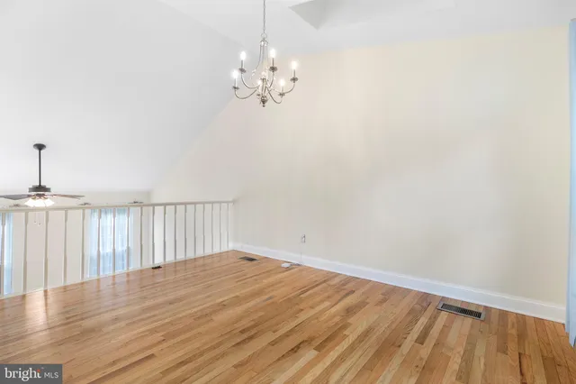 a view of a kitchen with furniture and wooden floor