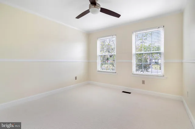 a view of empty room with wooden floor and fireplace