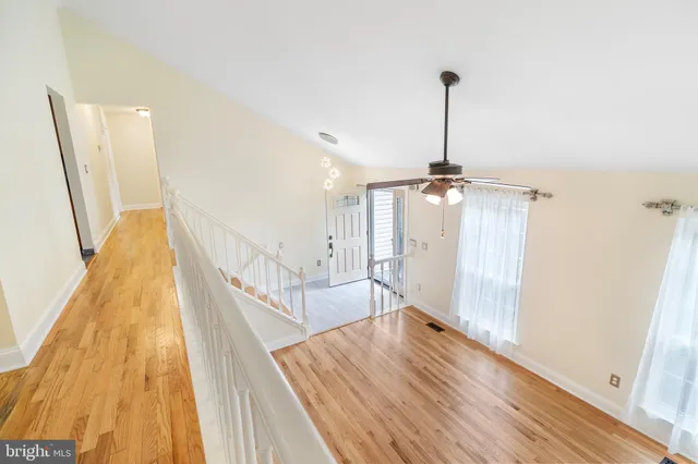 a view of a room with wooden floor and stairs