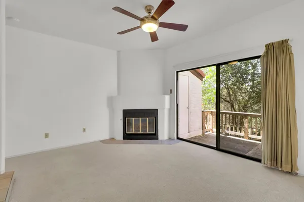 a view of empty room with fireplace