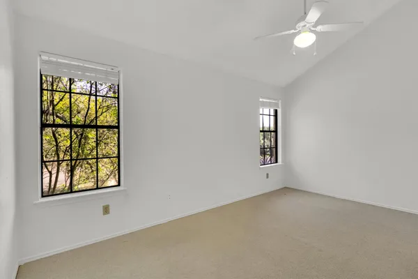 an empty room with windows and closet