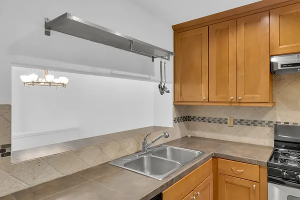 a kitchen that has a sink and a stove