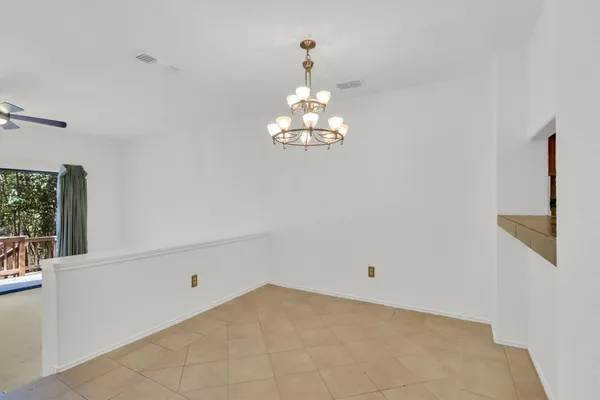 a view of a chandelier fan and entryway