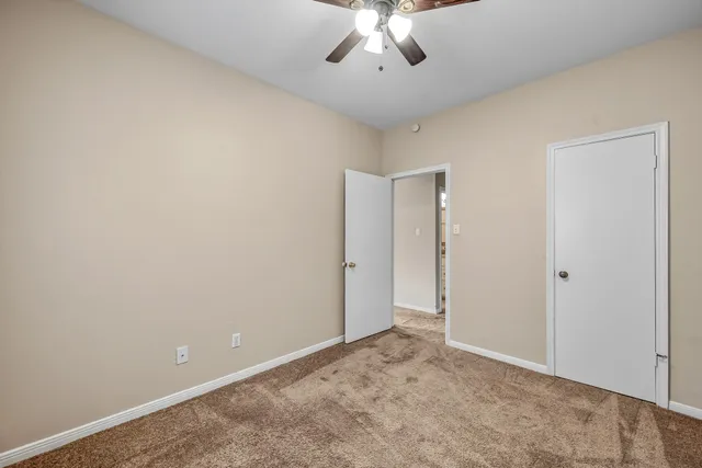 a bathroom with a granite countertop sink toilet mirror and shower