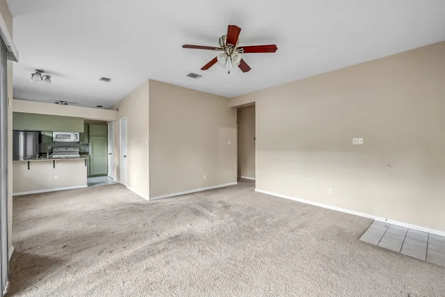 a view of a kitchen with a sink and a window