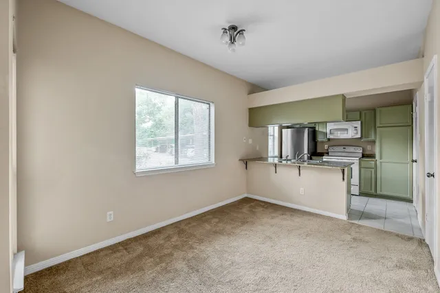 a kitchen with stainless steel appliances granite countertop a sink a stove and a refrigerator
