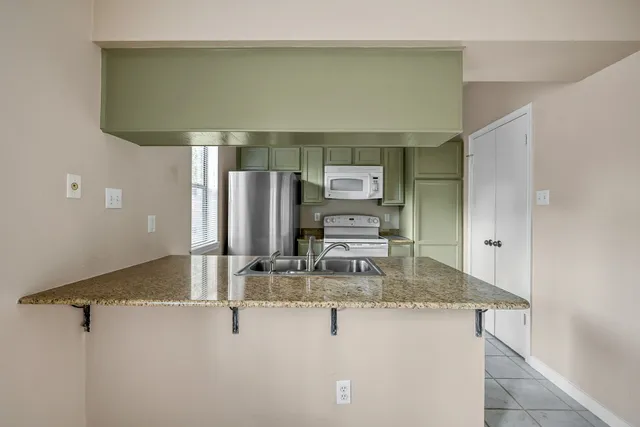 a kitchen with a stove microwave and refrigerator
